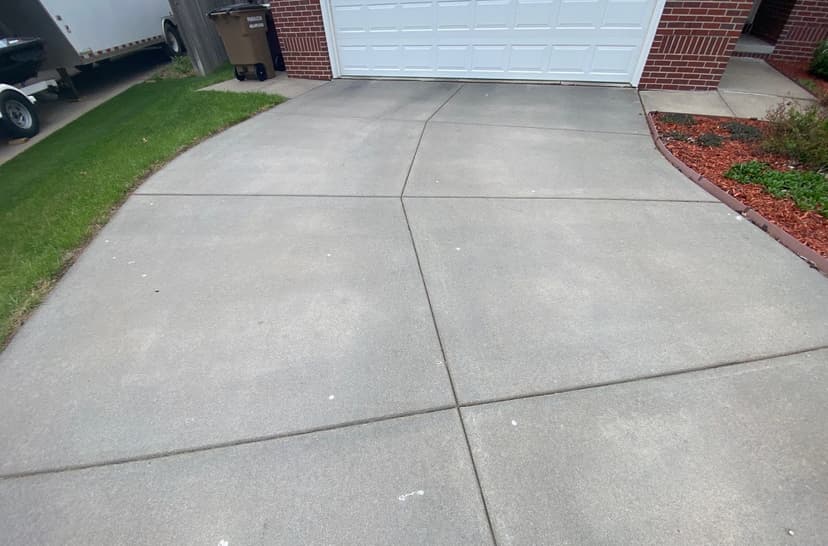 Epp Foundation Repair inspecting cracking expansion joints on a concrete driveway in Lincoln, NE.