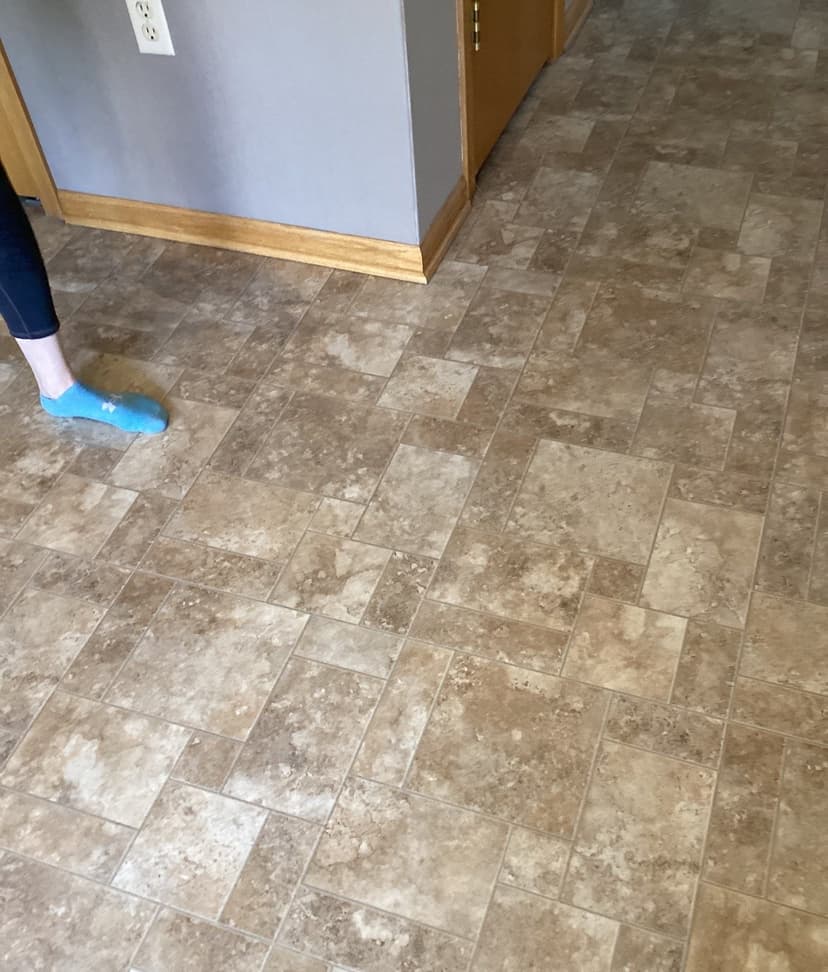 Epp Foundation Repair inspecting sagging vinyl tile floor in a home in Lincoln, nebraska.