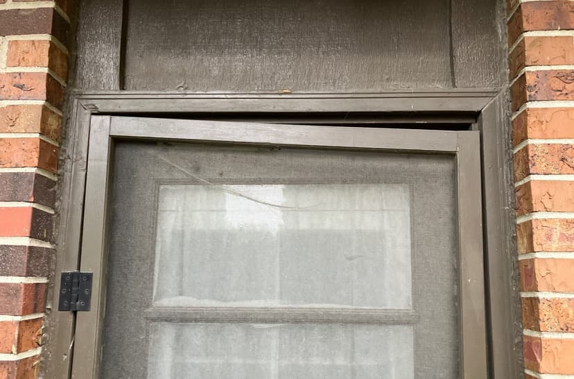 Epp Foundation Repair inspecting a misaligned and warped screen door frame due to potential foundation issues.