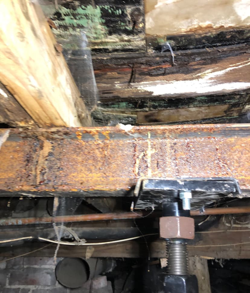 Epp Foundation Repair installing crawl space jacks to support rotten floor joists in a Lincoln, NE crawl space.