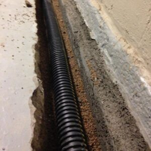 Excess moisture in the soil now flows into the pipe and toward the sump pit.