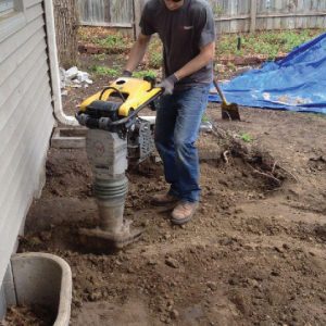 Replacing and compacting soil after push pier installating